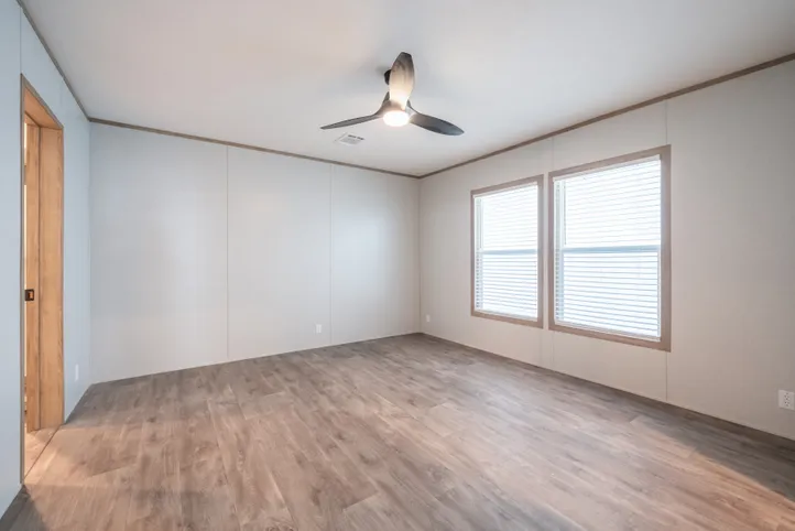 The BLUEBONNET BREEZE Primary Bedroom. This Manufactured Mobile Home features 3 bedrooms and 2 baths.