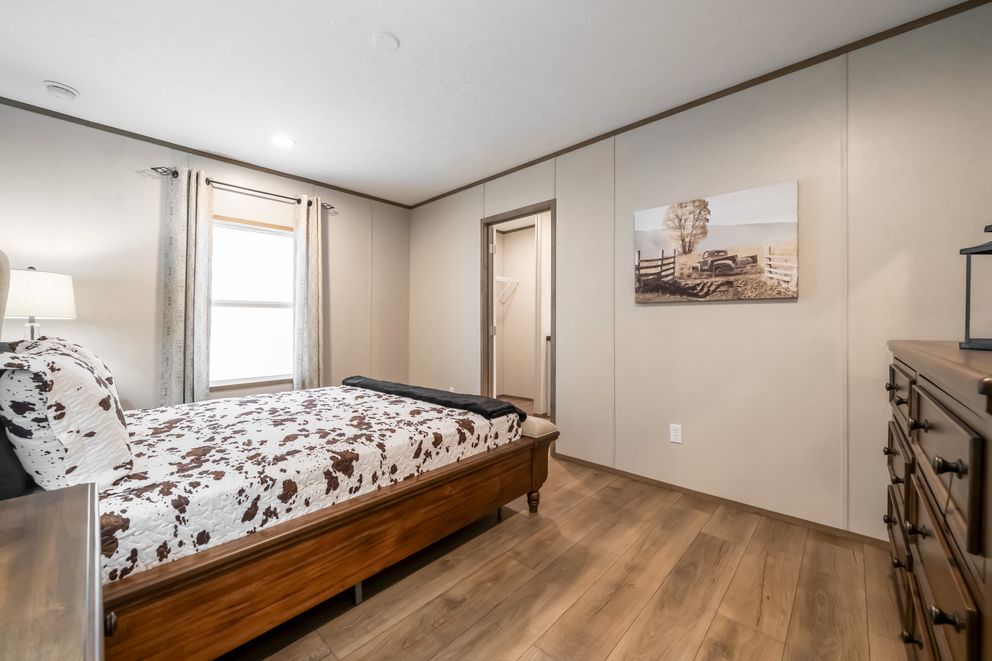 The HORIZON BEACON 16663A Primary Bedroom. This Manufactured Mobile Home features 3 bedrooms and 2 baths.