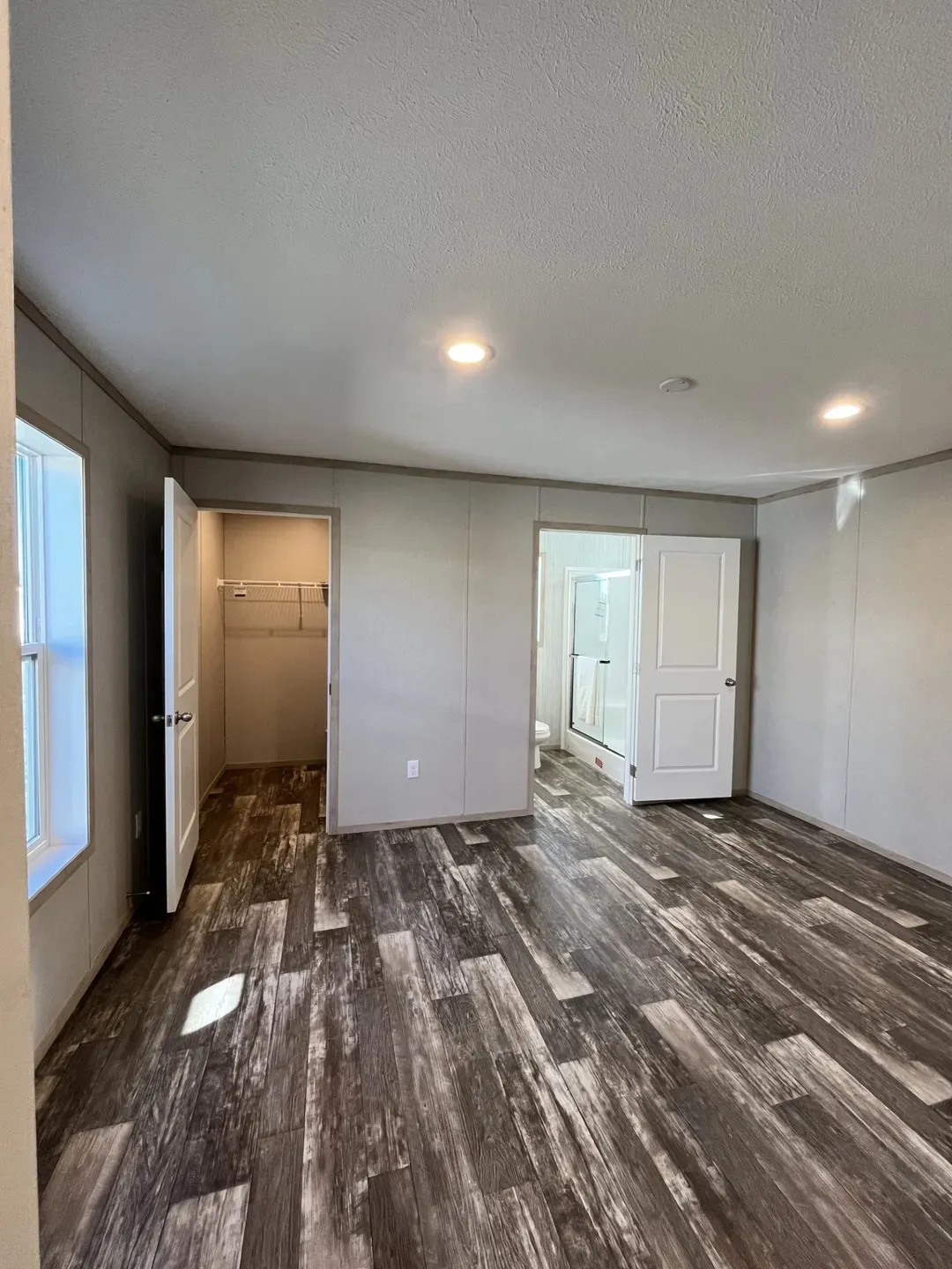 The SAPPHIRE Primary Bedroom. This Manufactured Mobile Home features 3 bedrooms and 2 baths.