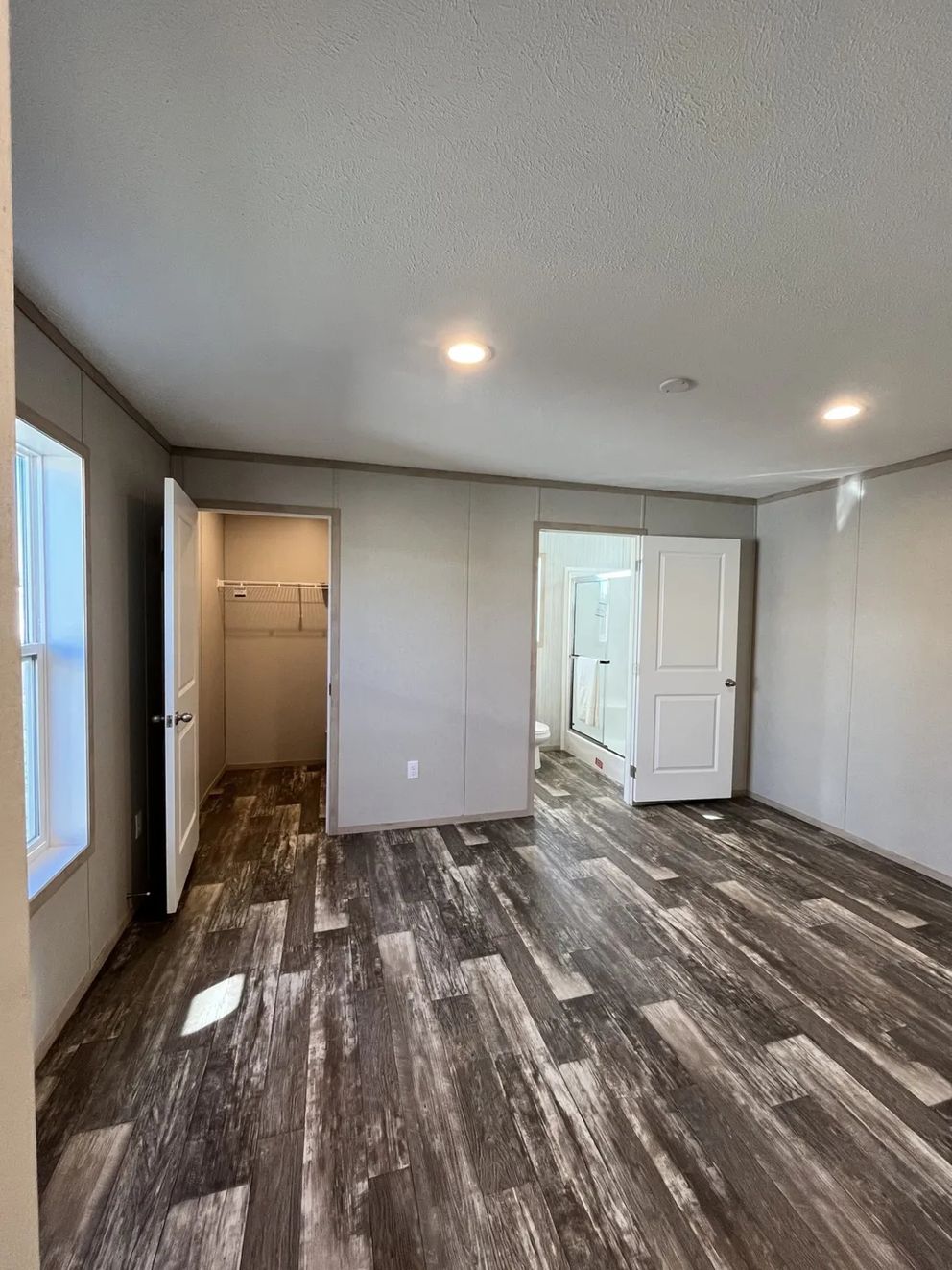 The SAPPHIRE Primary Bedroom. This Manufactured Mobile Home features 3 bedrooms and 2 baths.