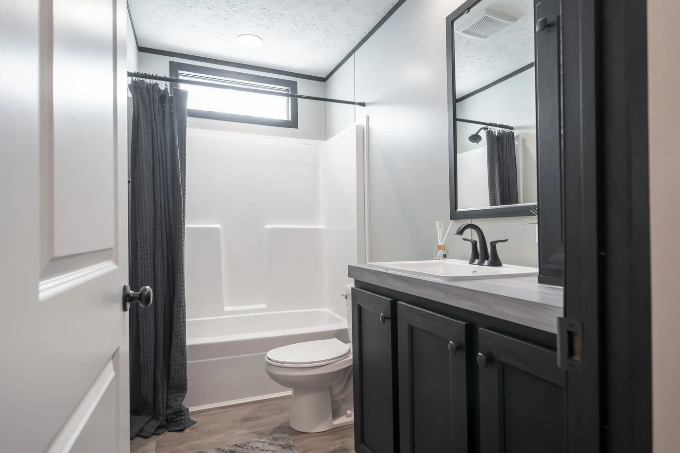 The CRAZY EIGHTS Guest Bathroom. This Manufactured Mobile Home features 4 bedrooms and 2 baths.