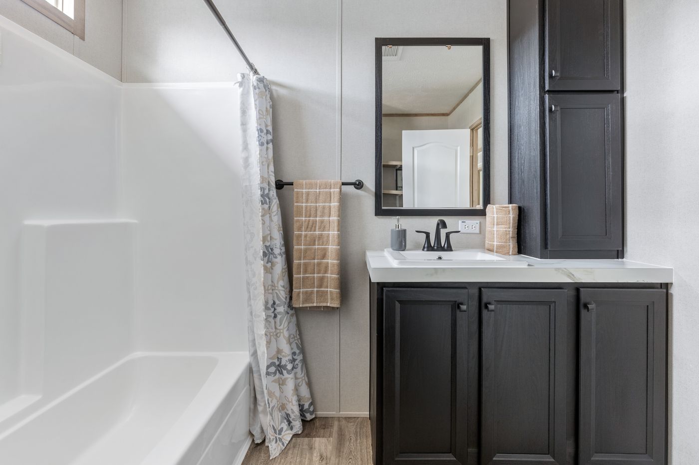 The STERLING XL ANNIVERSARY Guest Bathroom. This Manufactured Mobile Home features 3 bedrooms and 2 baths.