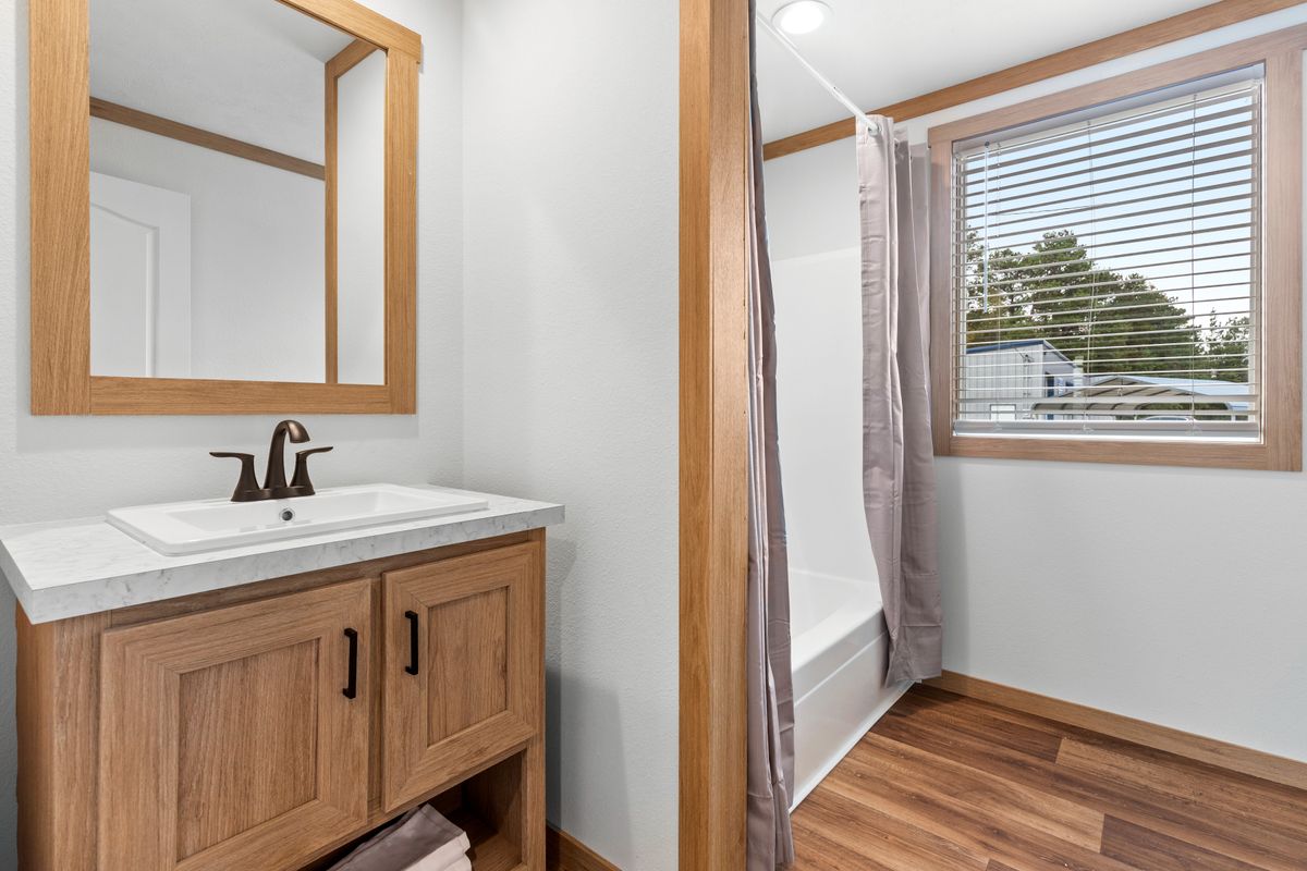 The THATCHER Guest Bathroom. This Manufactured Mobile Home features 4 bedrooms and 2 baths.
