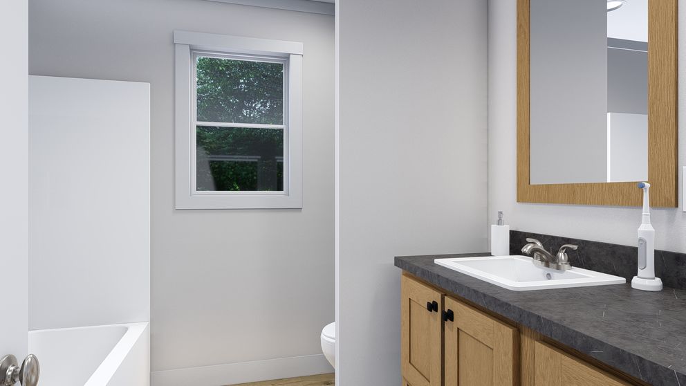 The LOVELY DAY Guest Bathroom. This Manufactured Mobile Home features 4 bedrooms and 2 baths.