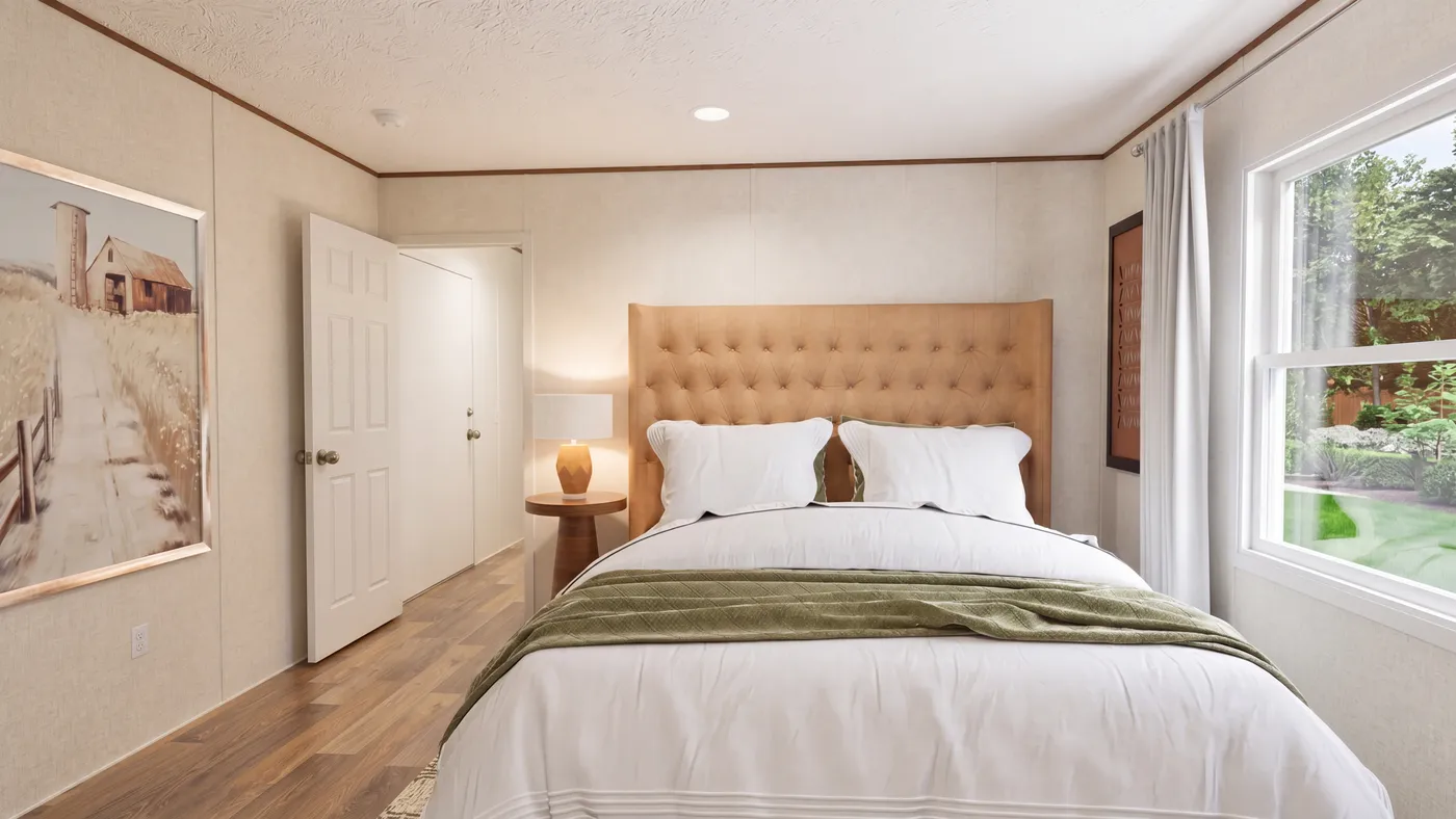 The DOGWOOD Primary Bedroom. This Manufactured Mobile Home features 2 bedrooms and 2 baths.