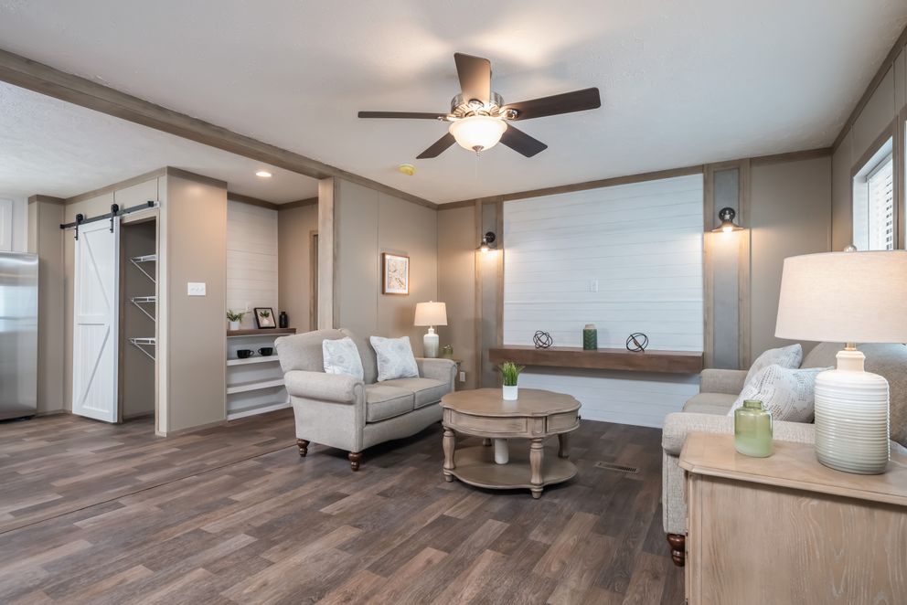 The FARMHOUSE BREEZE 72 Living Room. This Manufactured Mobile Home features 4 bedrooms and 2 baths.