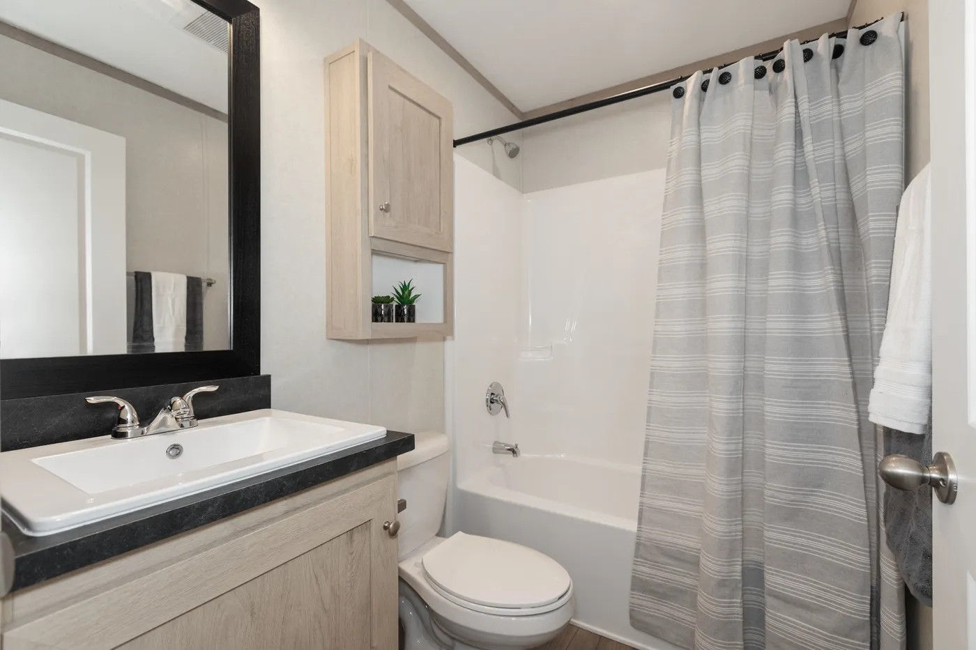 The 7616-4200 ADRENALINE Guest Bathroom. This Manufactured Mobile Home features 3 bedrooms and 2 baths.