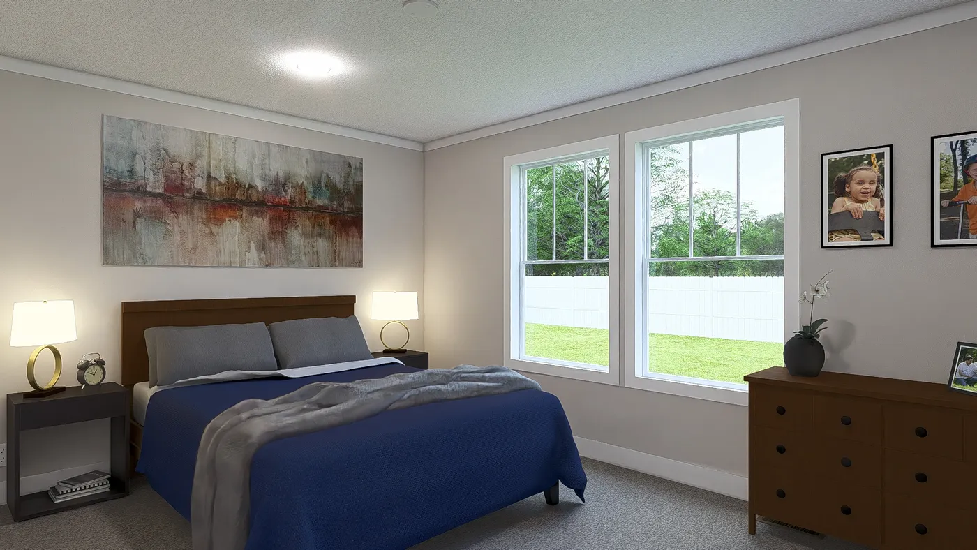 The THREE LITTLE BIRDS Primary Bedroom. This Manufactured Mobile Home features 3 bedrooms and 2 baths.