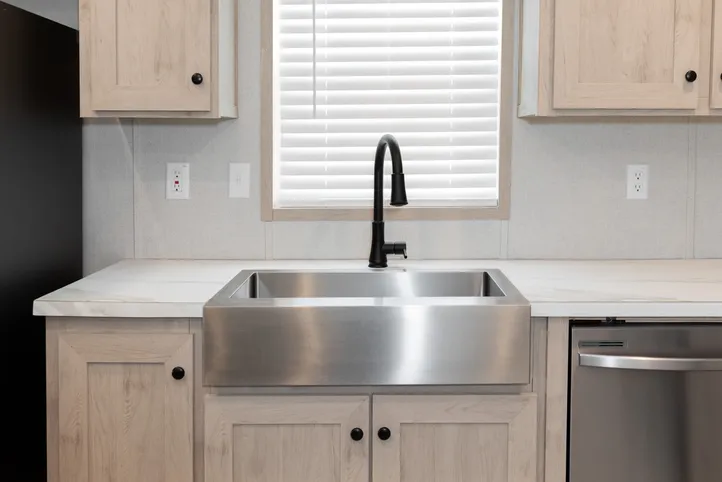 The THE ANNIVERSARY ISLANDER Kitchen. This Manufactured Mobile Home features 3 bedrooms and 2 baths.