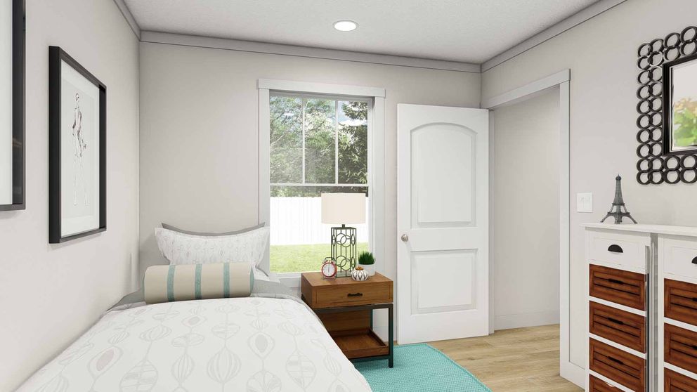 The SATISFACTION Guest Bedroom. This Manufactured Mobile Home features 2 bedrooms and 1 bath.