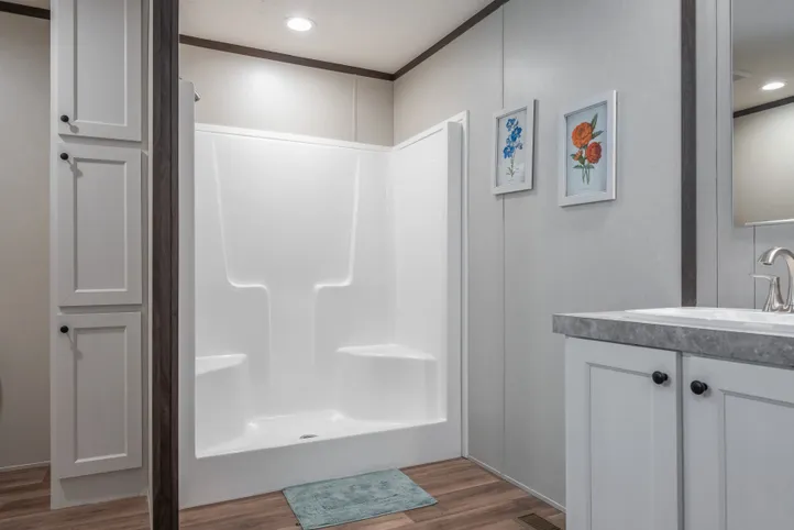 The EMPOWER Primary Bathroom. This Manufactured Mobile Home features 4 bedrooms and 2 baths.