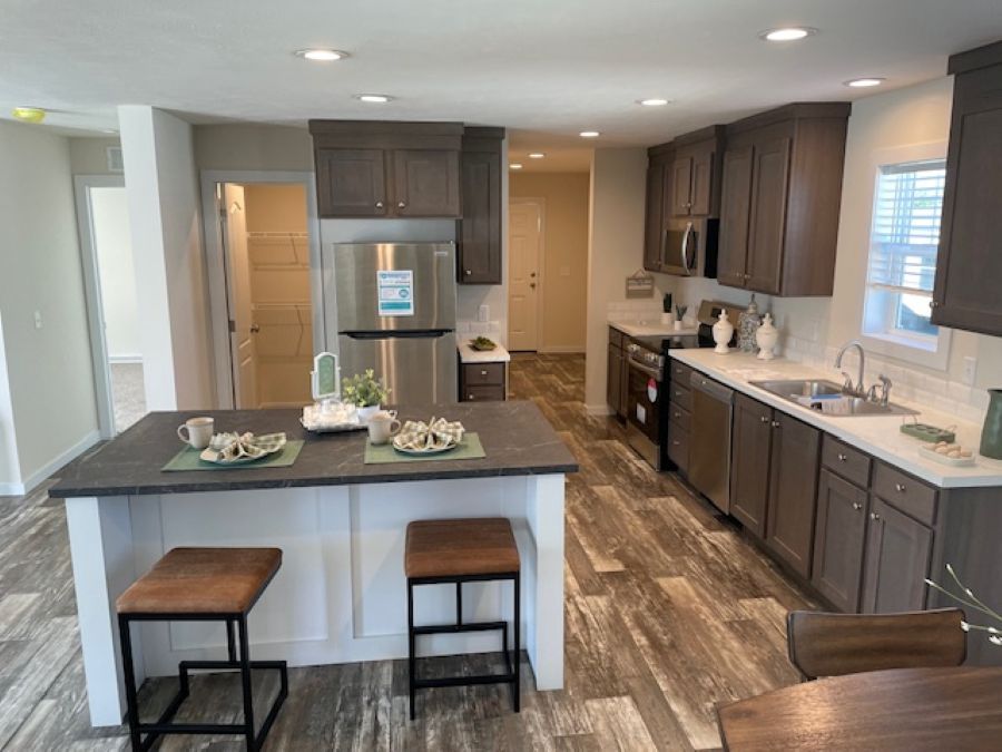 The AURORA PLACE 5228-MS049-1 SECT Kitchen. This Manufactured Mobile Home features 3 bedrooms and 2 baths.