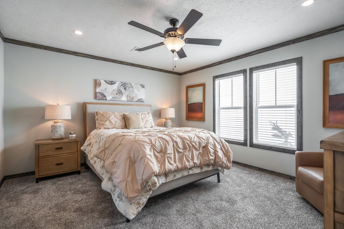 The THE JACKSON Primary Bedroom. This Manufactured Mobile Home features 4 bedrooms and 2 baths.