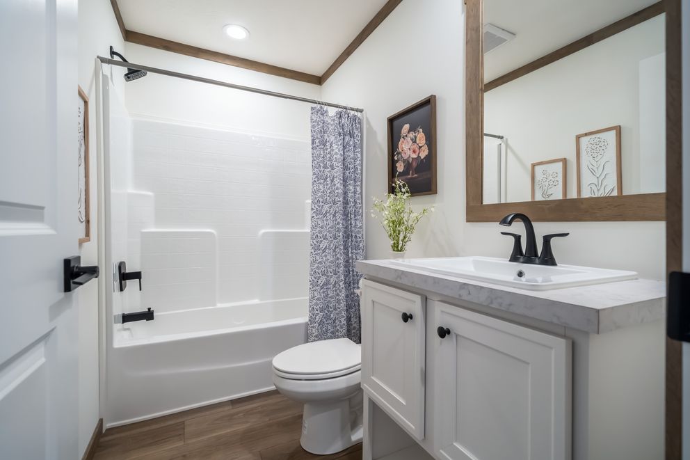 The THE LIZZIE Guest Bathroom. This Manufactured Mobile Home features 3 bedrooms and 2 baths.