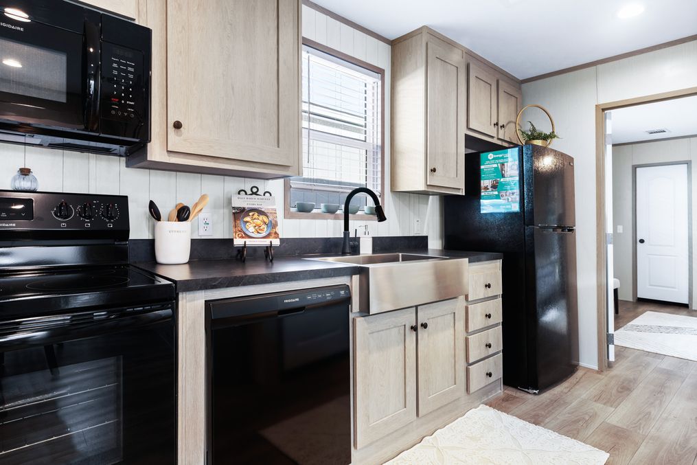 The ANNIVERSARY 16763A Kitchen. This Manufactured Mobile Home features 3 bedrooms and 2 baths.