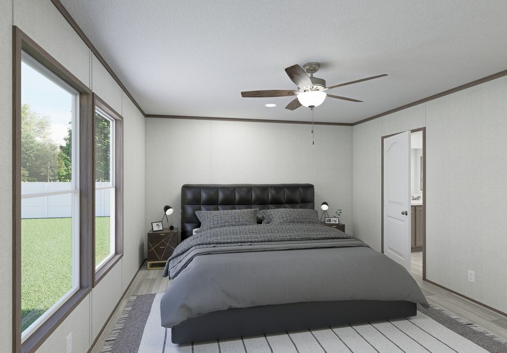 The THE MOUNTAINEER 64 Primary Bedroom. This Manufactured Mobile Home features 3 bedrooms and 2 baths.