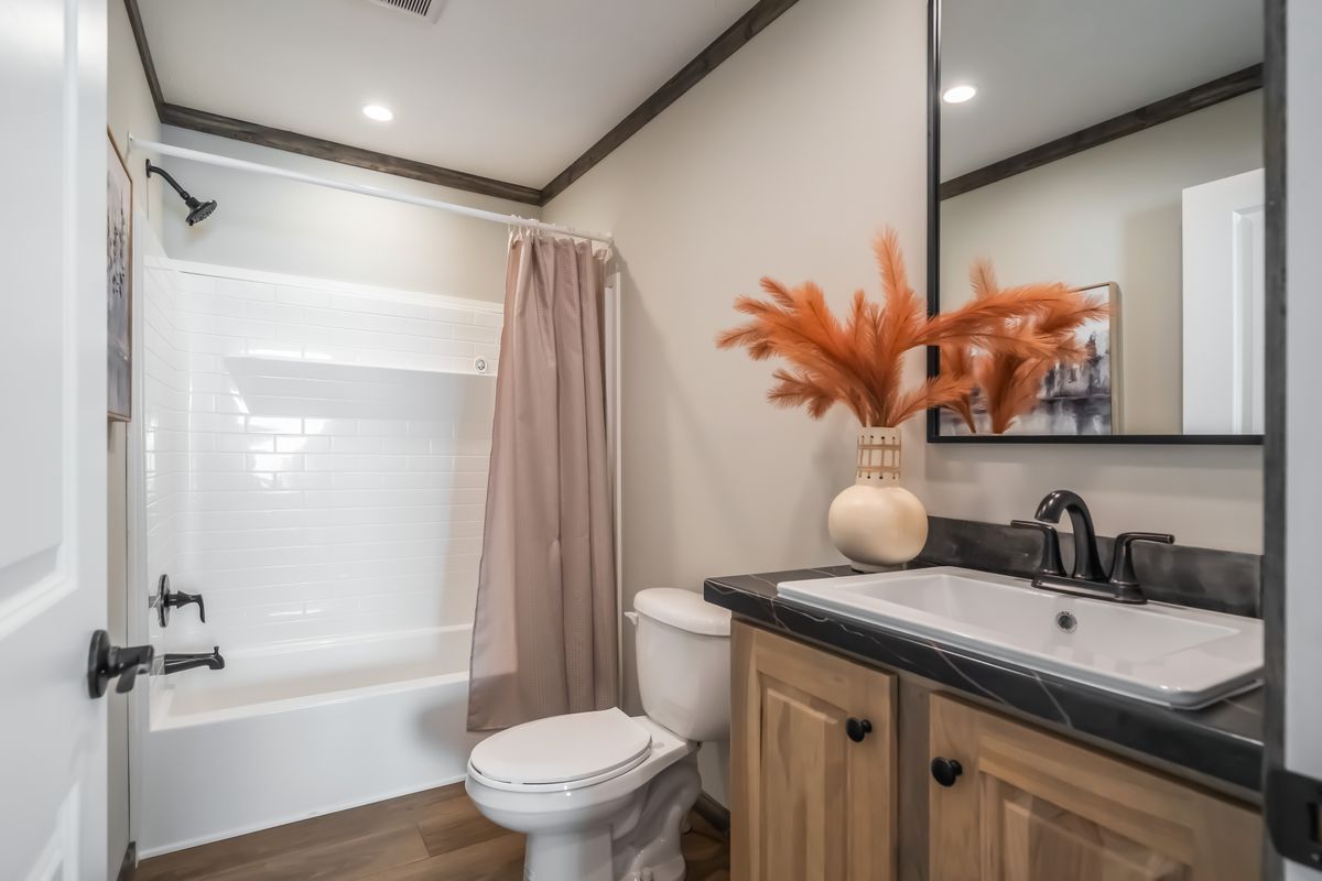 The THE JACKSON Guest Bathroom. This Manufactured Mobile Home features 4 bedrooms and 2 baths.
