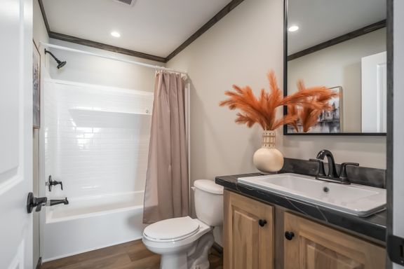 The THE JACKSON Guest Bathroom. This Manufactured Mobile Home features 4 bedrooms and 2 baths.