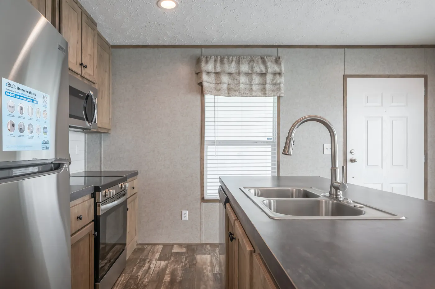 The LAKESIDE COTTAGE Kitchen. This Manufactured Mobile Home features 1 bedroom and 1 bath.