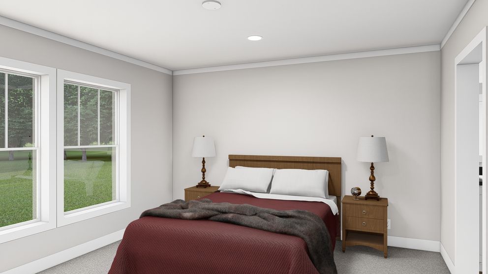 The LET IT BE Primary Bedroom. This Manufactured Mobile Home features 3 bedrooms and 2 baths.