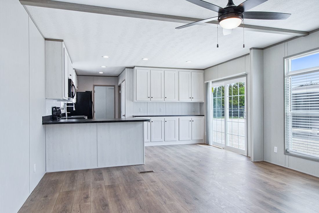 The ANNIVERSARY 16682A Dining Area. This Manufactured Mobile Home features 2 bedrooms and 2 baths.