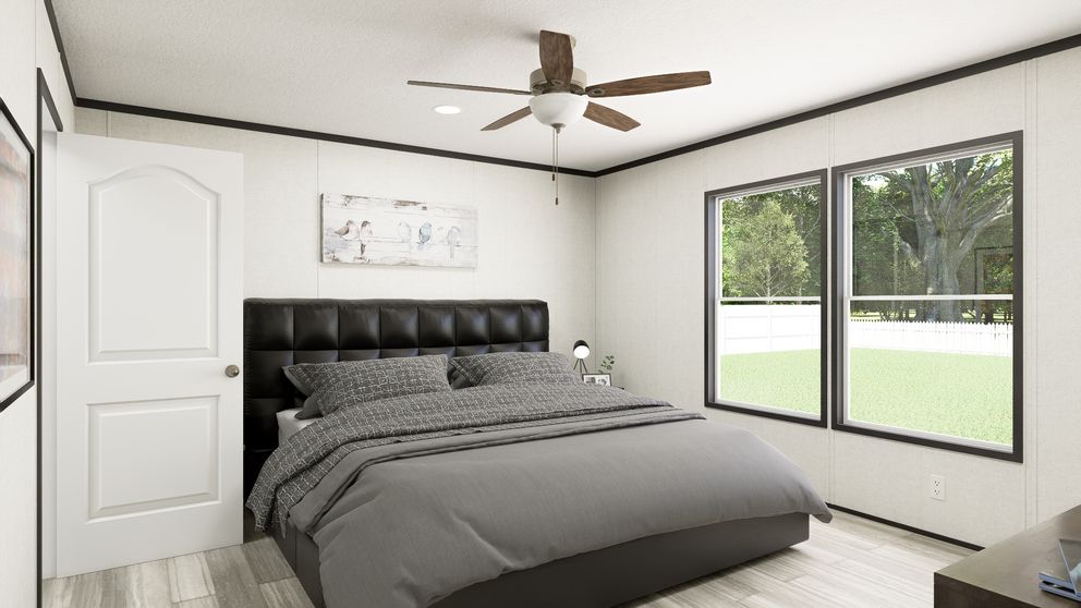 The THE MOUNTAINEER 56 Primary Bedroom. This Manufactured Mobile Home features 3 bedrooms and 2 baths.