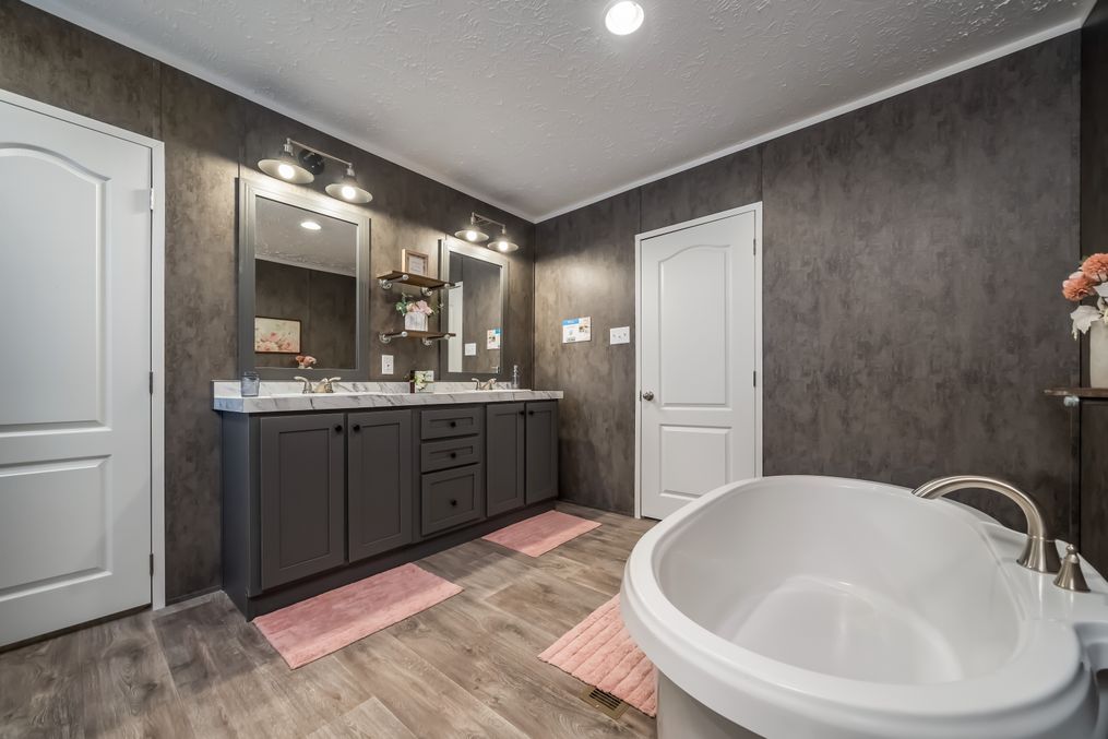 The THE FUSION 32B Primary Bathroom. This Manufactured Mobile Home features 4 bedrooms and 2 baths.