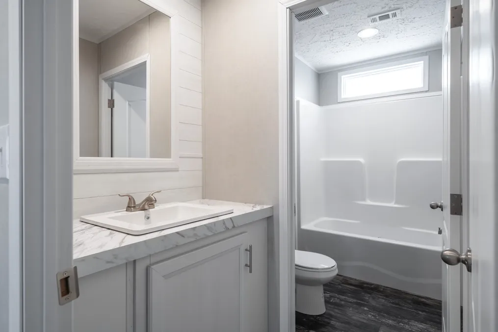 The ALL AMERICAN Guest Bathroom. This Manufactured Mobile Home features 3 bedrooms and 2 baths.