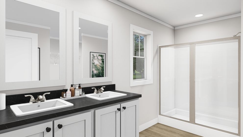 The LET IT BE Primary Bathroom. This Manufactured Mobile Home features 3 bedrooms and 2 baths.