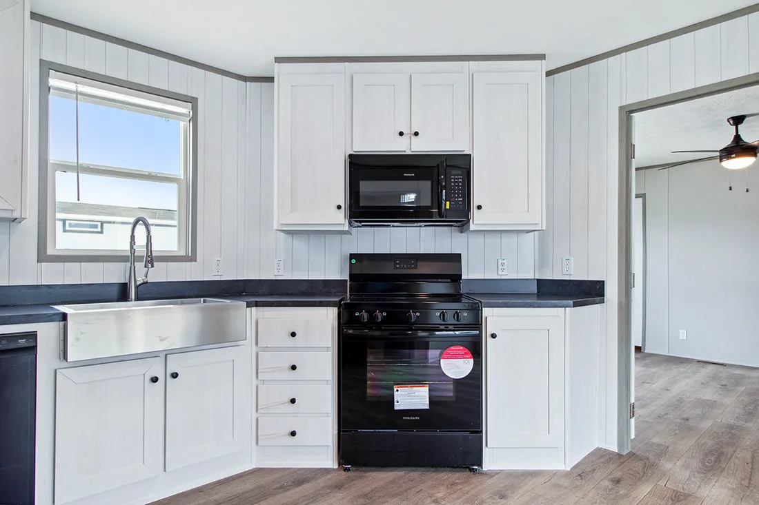 The ANNIVERSARY 16682F Kitchen. This Manufactured Mobile Home features 2 bedrooms and 2 baths.