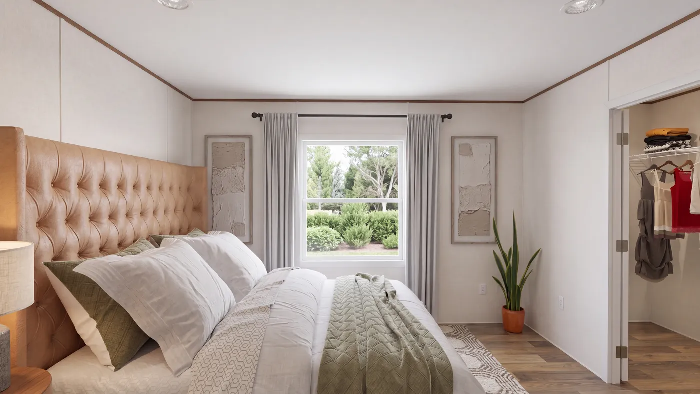 The DOGWOOD Primary Bedroom. This Manufactured Mobile Home features 2 bedrooms and 2 baths.