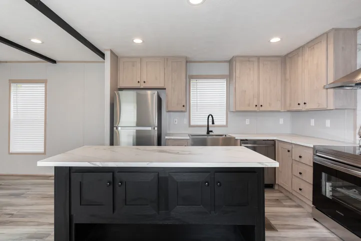 The THE ANNIVERSARY ISLANDER Kitchen. This Manufactured Mobile Home features 3 bedrooms and 2 baths.