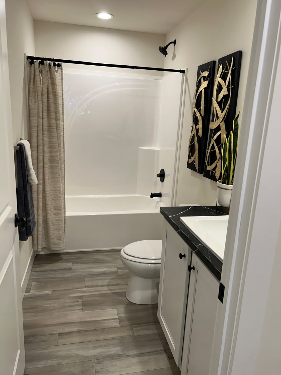 The STRATFORD PL 6630-MS062 SECT Guest Bathroom. This Manufactured Mobile Home features 3 bedrooms and 2 baths.