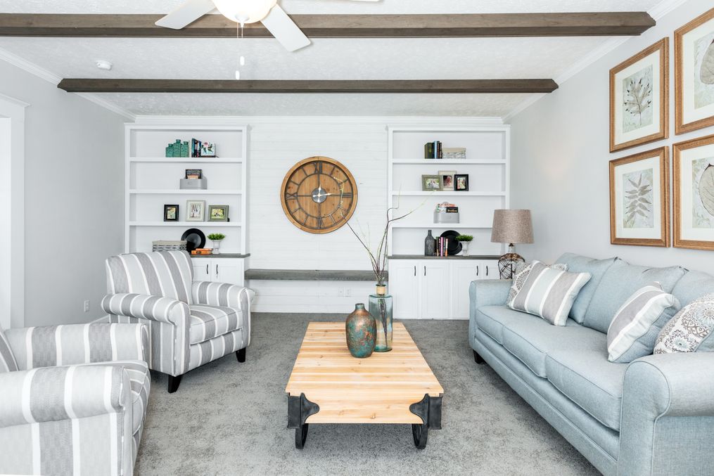 The COUNTRY AIRE Living Room. This Manufactured Mobile Home features 3 bedrooms and 3 baths.
