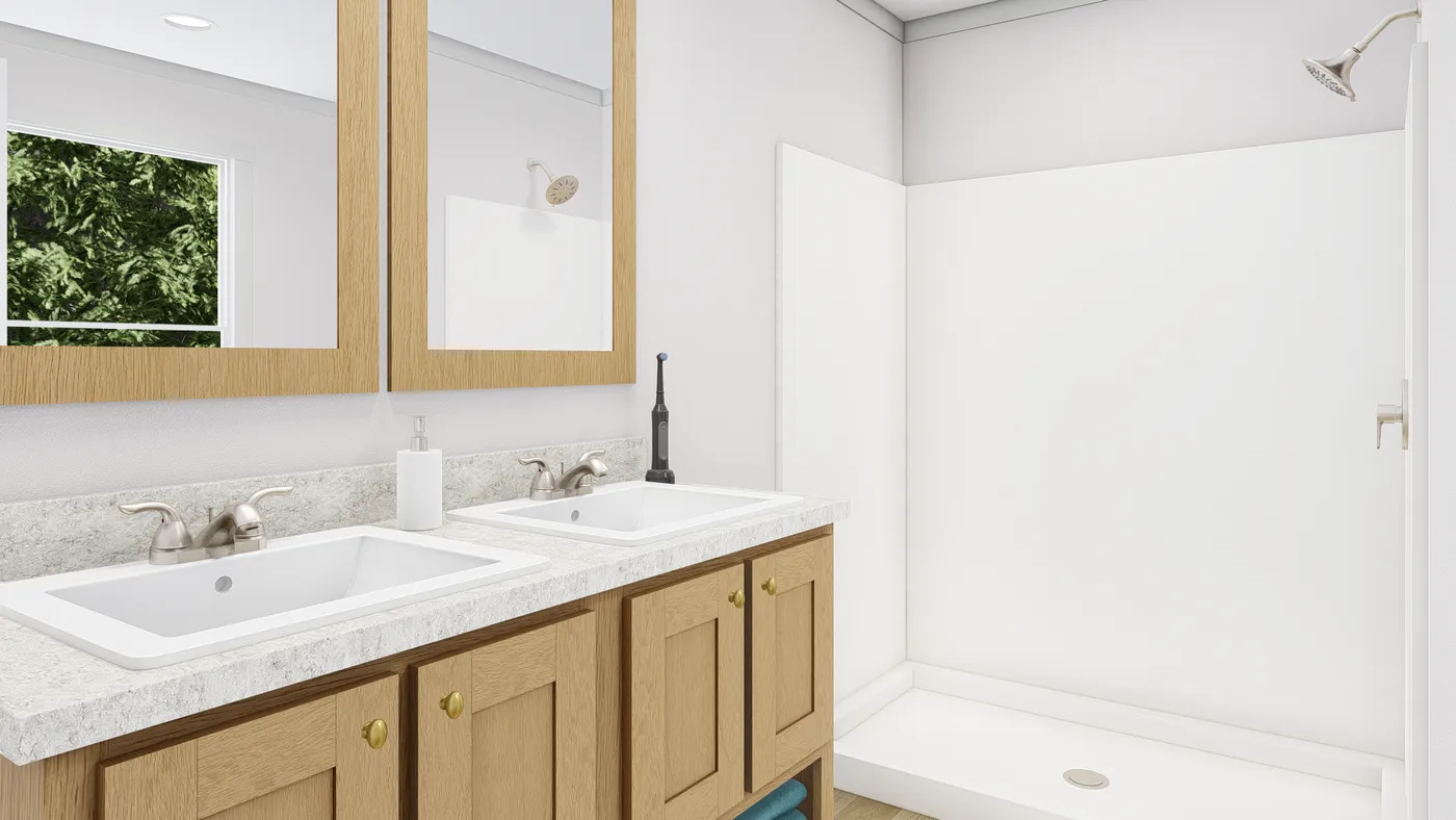 The HERE COMES THE SUN Primary Bathroom. This Manufactured Mobile Home features 3 bedrooms and 2 baths.