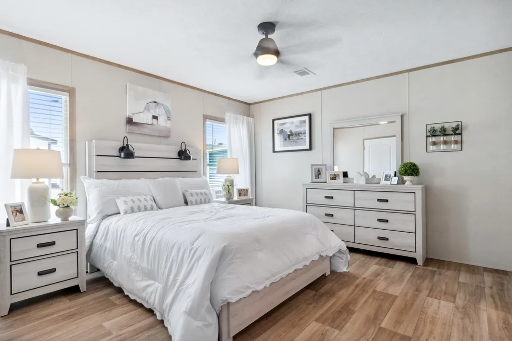 The BREEZE FARMHOUSE 72 Primary Bedroom. This Manufactured Mobile Home features 4 bedrooms and 2 baths.
