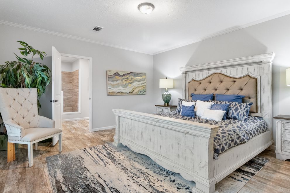 The THE BRYANT Primary Bedroom. This Manufactured Mobile Home features 4 bedrooms and 2 baths.