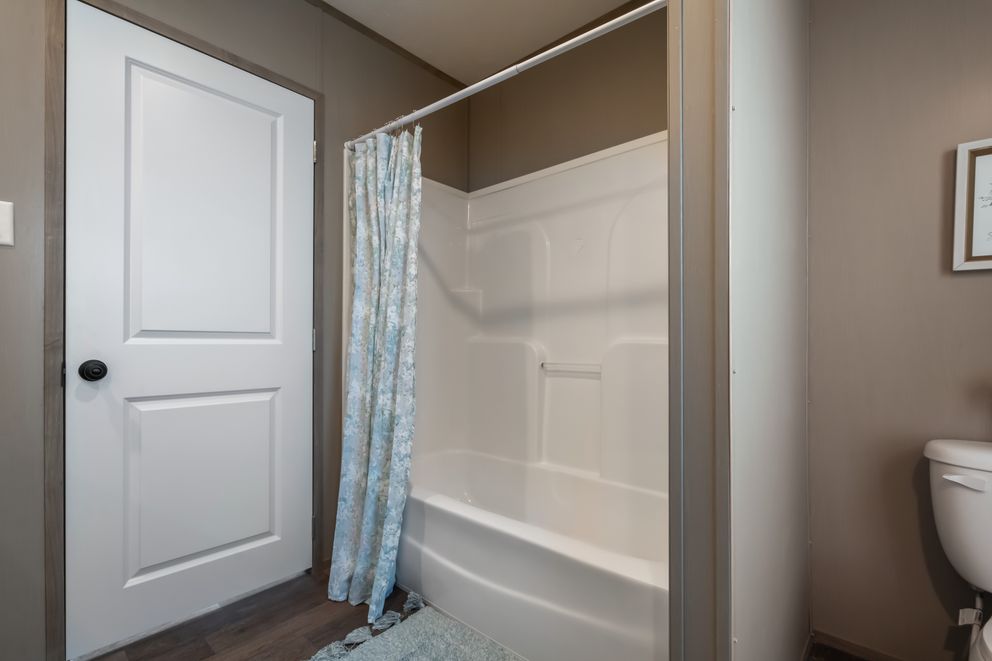 The FARMHOUSE BREEZE 72 Guest Bathroom. This Manufactured Mobile Home features 4 bedrooms and 2 baths.