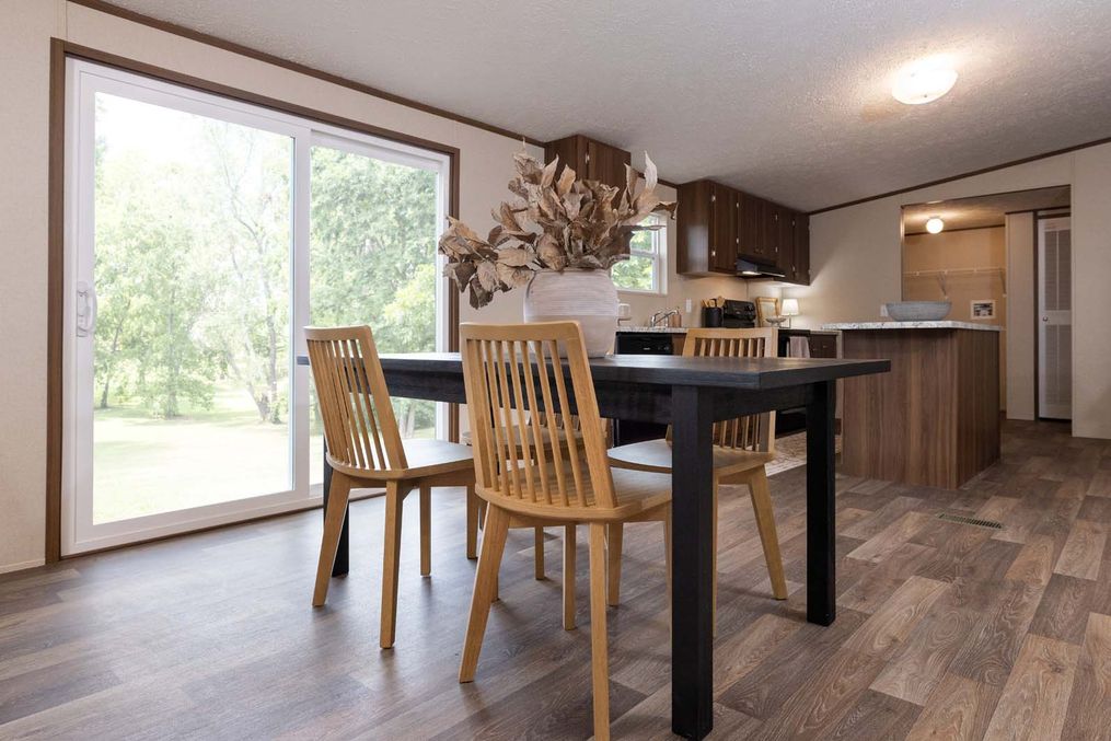 The PRIDE Dining Area. This Manufactured Mobile Home features 4 bedrooms and 2 baths.