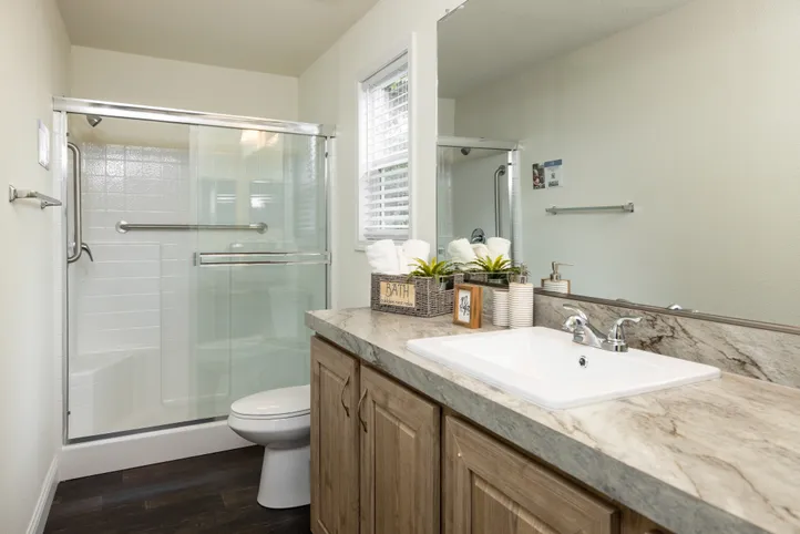 The FAIRPOINT 24403A Primary Bathroom. This Manufactured Mobile Home features 3 bedrooms and 2 baths.