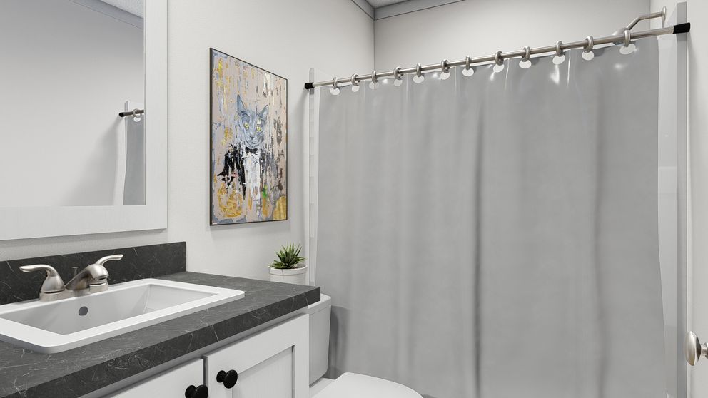 The BORN TO RUN Guest Bathroom. This Manufactured Mobile Home features 2 bedrooms and 2 baths.