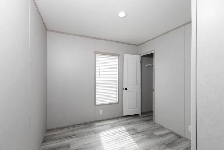 The THE ANNIVERSARY ISLANDER Guest Bedroom. This Manufactured Mobile Home features 3 bedrooms and 2 baths.