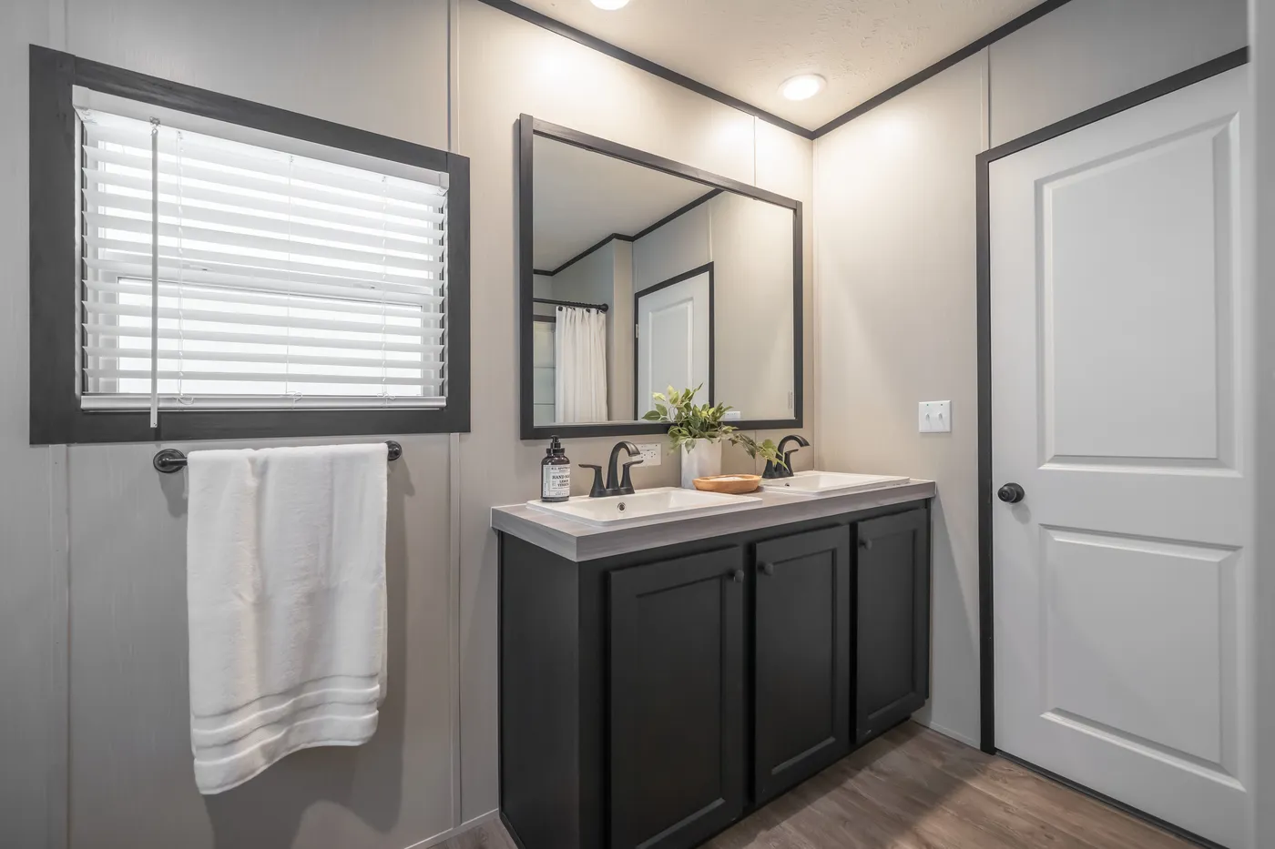 The CRAZY EIGHTS Primary Bathroom. This Manufactured Mobile Home features 4 bedrooms and 2 baths.