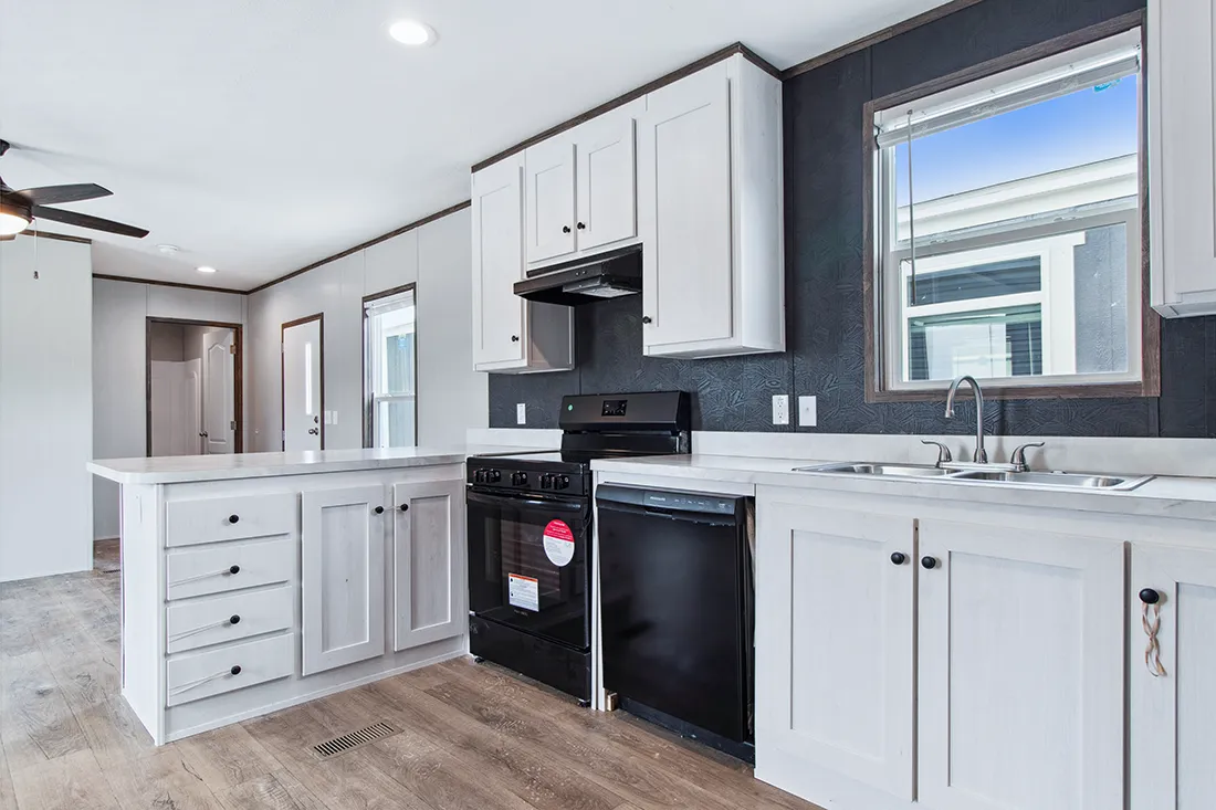 The HOMESTEAD 16562A Kitchen. This Manufactured Mobile Home features 2 bedrooms and 2 baths.