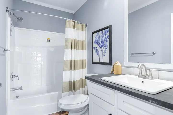 The THE ATLAS Guest Bathroom. This Manufactured Mobile Home features 4 bedrooms and 3 baths.