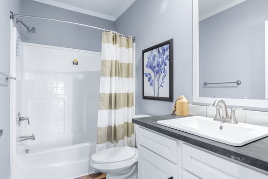 The THE ATLAS Guest Bathroom. This Manufactured Mobile Home features 4 bedrooms and 3 baths.