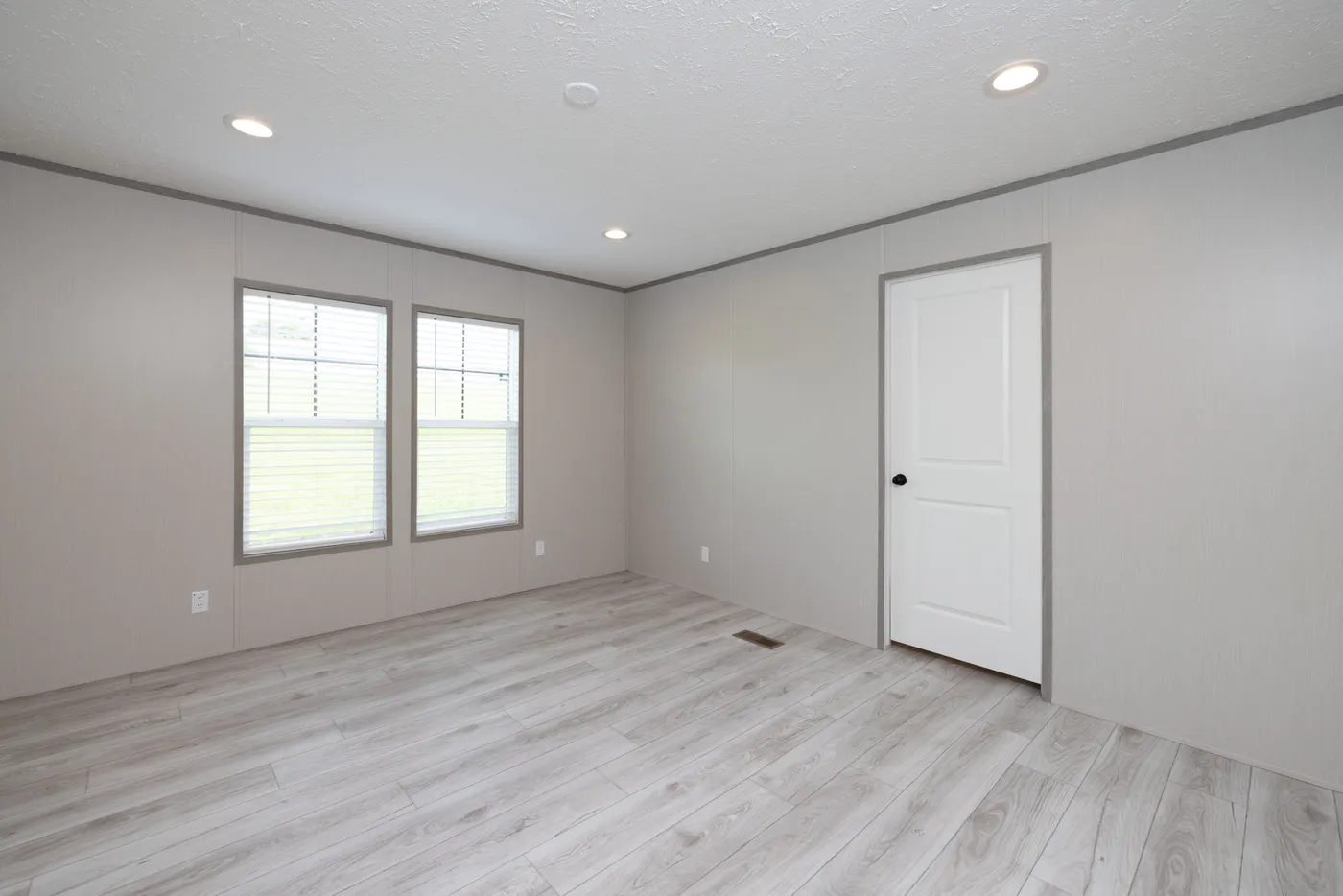 The SHOWER HOUSE Primary Bedroom. This Manufactured Mobile Home features 3 bedrooms and 2 baths.