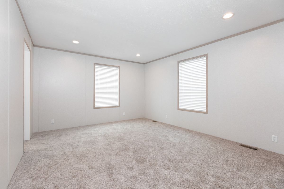 The 5628-5202 ADRENALINE Primary Bedroom. This Manufactured Mobile Home features 3 bedrooms and 2 baths.