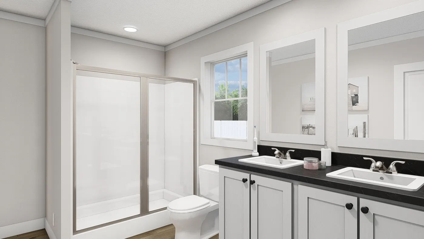 The THREE LITTLE BIRDS Primary Bathroom. This Manufactured Mobile Home features 3 bedrooms and 2 baths.