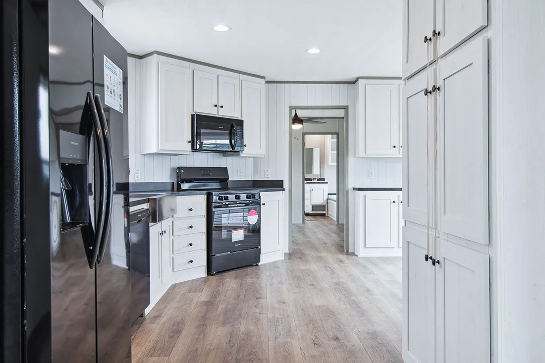The ANNIVERSARY 16682F Kitchen. This Manufactured Mobile Home features 2 bedrooms and 2 baths.
